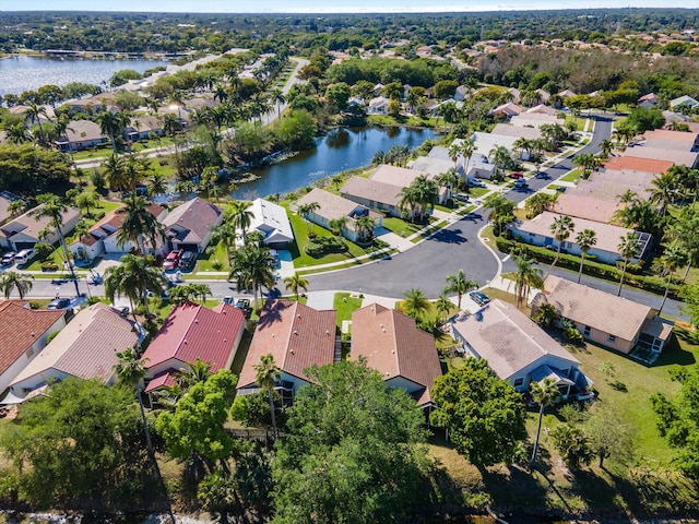 drone / aerial view featuring a residential view and a water view