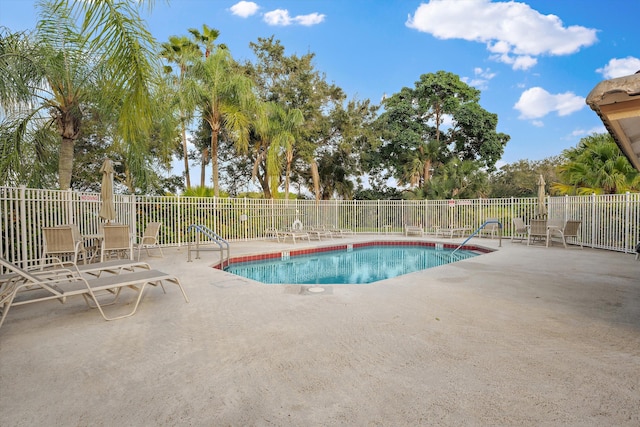 community pool featuring a patio area and fence