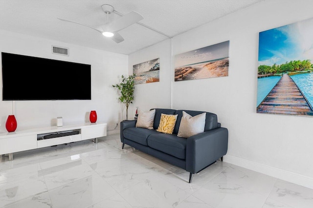 living area featuring baseboards, visible vents, ceiling fan, a textured ceiling, and marble finish floor