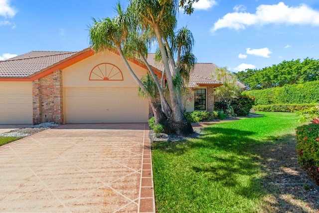 view of front of house with a front lawn, concrete driveway, a garage, brick siding, and a tiled roof