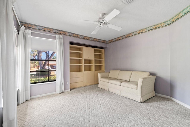 unfurnished room featuring visible vents, a ceiling fan, baseboards, and a textured ceiling