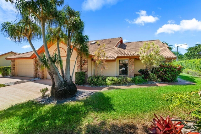 view of front facade featuring stucco siding, driveway, a tile roof, an attached garage, and a front yard