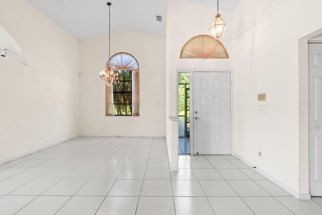 foyer with visible vents, baseboards, an inviting chandelier, light tile patterned flooring, and high vaulted ceiling