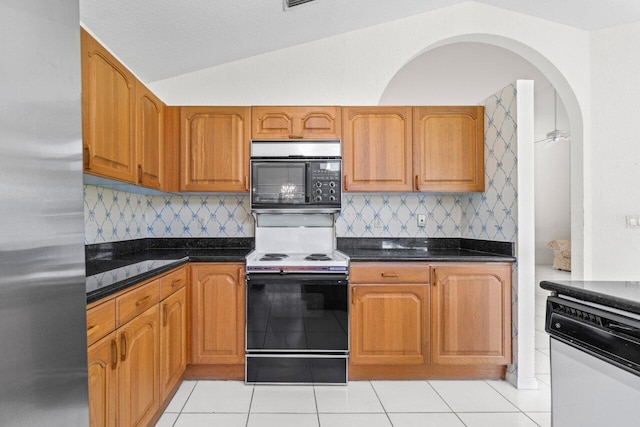 kitchen featuring range with electric cooktop, stainless steel refrigerator, black microwave, lofted ceiling, and dishwasher