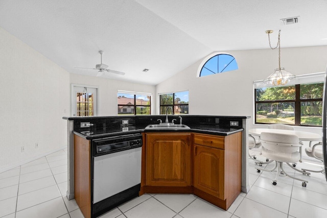 kitchen with visible vents, a sink, brown cabinetry, dishwasher, and vaulted ceiling