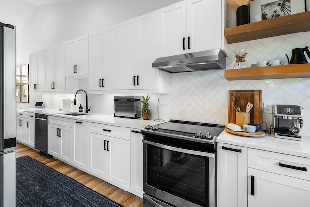 kitchen with open shelves, a sink, stainless steel appliances, light countertops, and under cabinet range hood