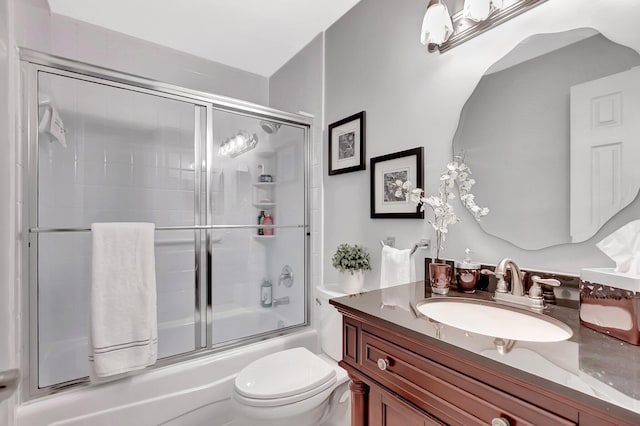 full bathroom with shower / bath combination with glass door, vanity, and toilet