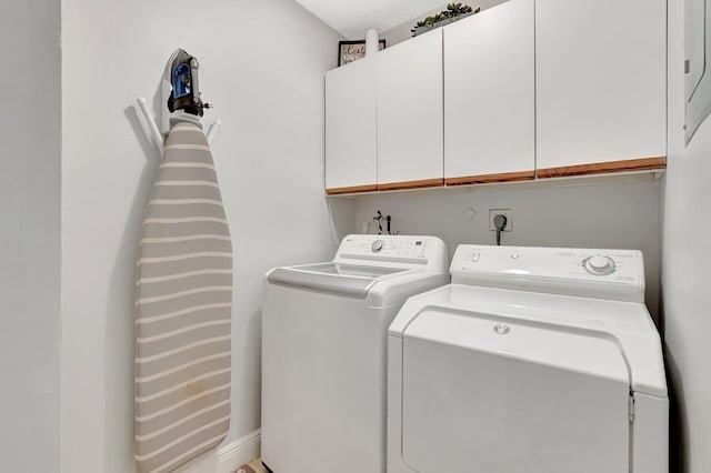 laundry room featuring cabinet space and washing machine and dryer