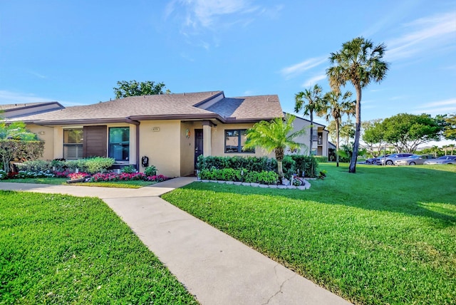 single story home featuring stucco siding, roof with shingles, and a front yard