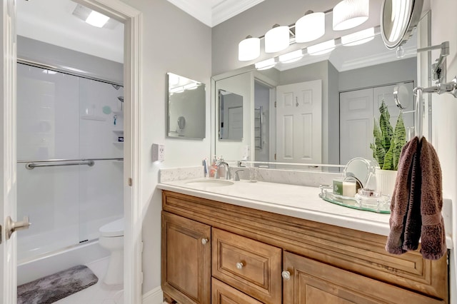 bathroom with vanity, a shower stall, toilet, and ornamental molding