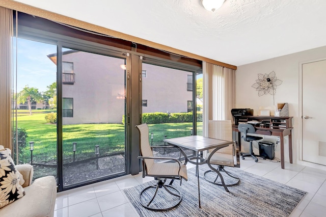 interior space featuring light tile patterned flooring and a textured ceiling