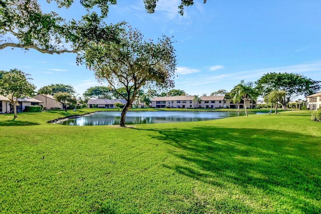 view of yard with a residential view and a water view