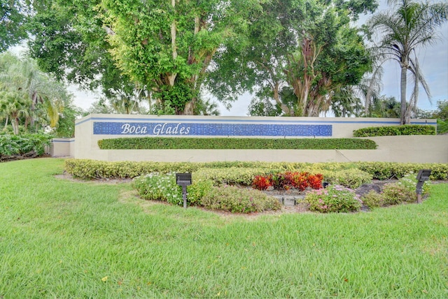 community / neighborhood sign with a lawn