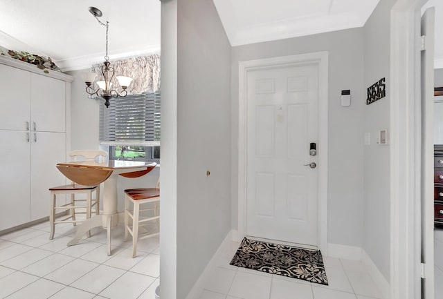 entryway featuring light tile patterned floors, baseboards, an inviting chandelier, and ornamental molding