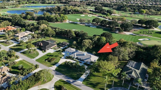 bird's eye view with golf course view, a water view, and a residential view