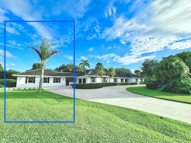 ranch-style house with concrete driveway and a front yard