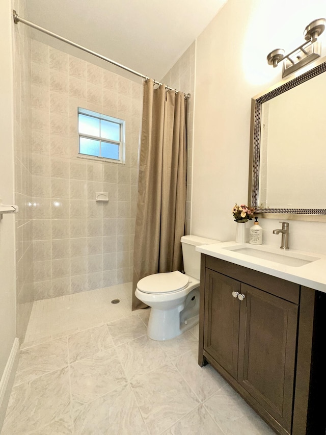 bathroom with tiled shower, toilet, and vanity