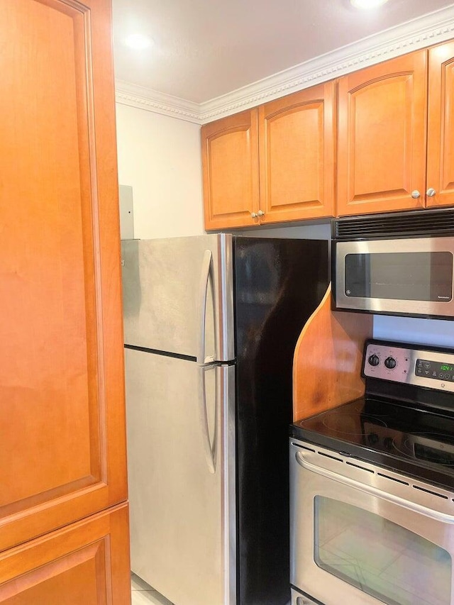 kitchen with stainless steel appliances and crown molding