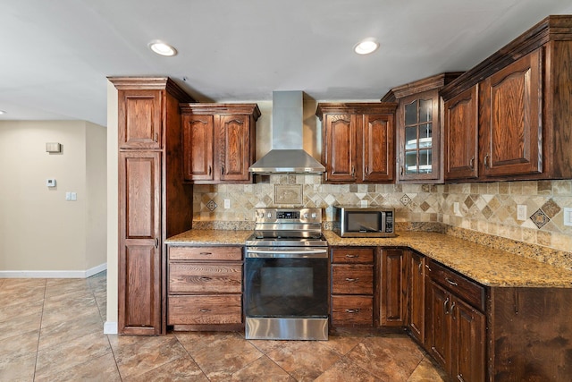 kitchen with light stone counters, stainless steel appliances, decorative backsplash, baseboards, and extractor fan