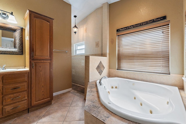 bathroom featuring tile patterned flooring, vanity, and a whirlpool tub