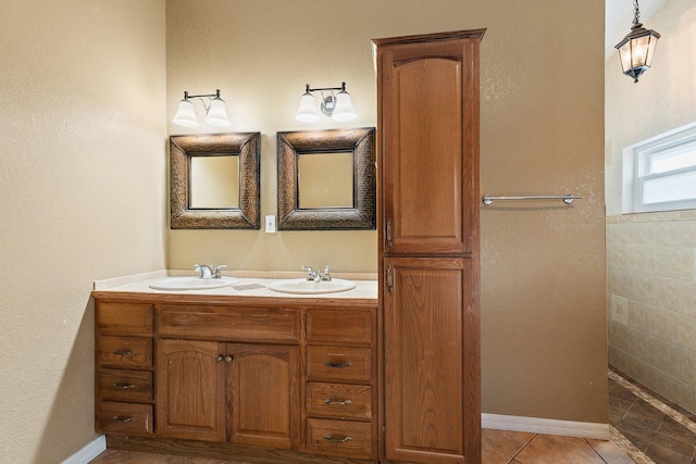 bathroom featuring a sink, walk in shower, double vanity, and tile patterned flooring