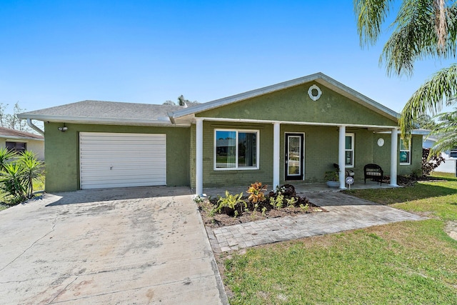 ranch-style house featuring stucco siding, a front lawn, concrete driveway, a garage, and brick siding