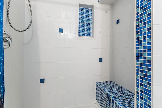 bathroom with a tile shower