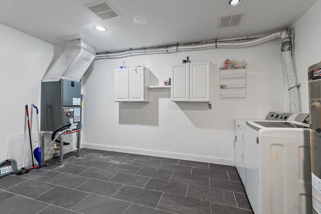 laundry area featuring baseboards, cabinet space, visible vents, and washer and clothes dryer