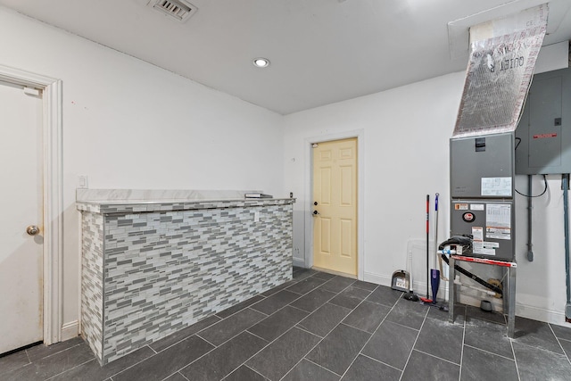 interior space featuring visible vents and dark tile patterned floors