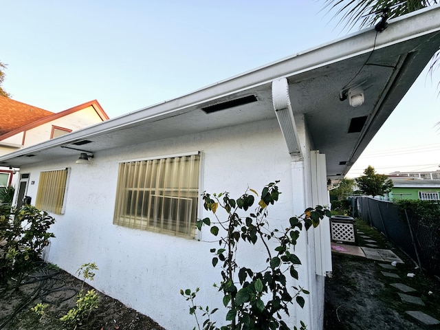 view of home's exterior featuring fence and stucco siding