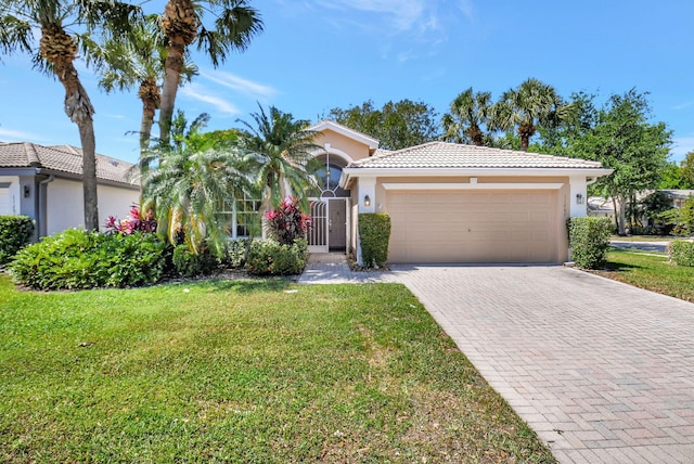 view of front of home featuring an attached garage, stucco siding, a front lawn, a tiled roof, and decorative driveway