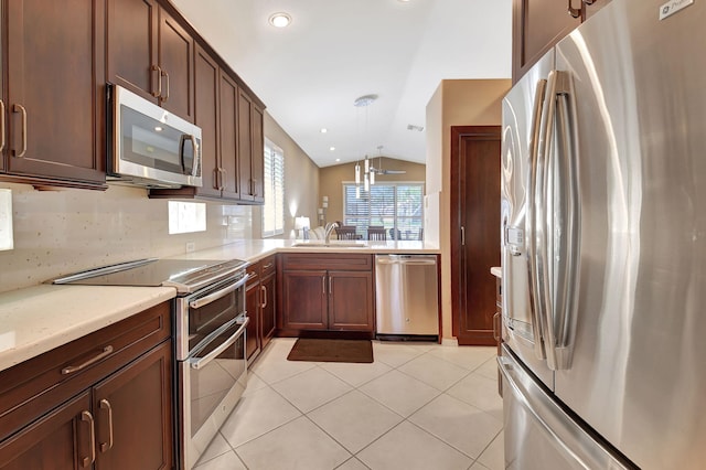 kitchen featuring a sink, stainless steel appliances, light tile patterned floors, decorative backsplash, and lofted ceiling