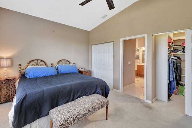 bedroom featuring visible vents, ceiling fan, high vaulted ceiling, light carpet, and ensuite bath