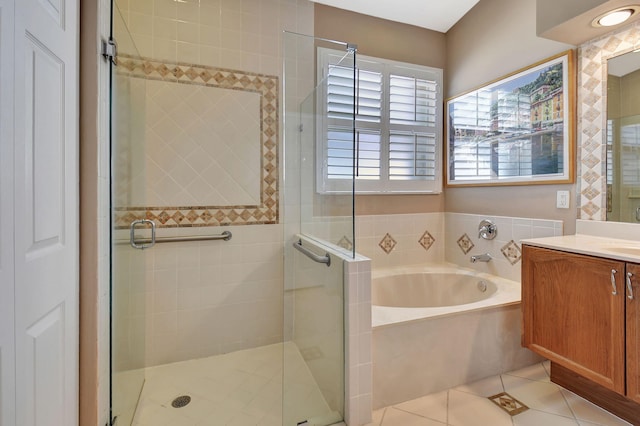 full bath with a bath, tile patterned floors, vanity, and a stall shower