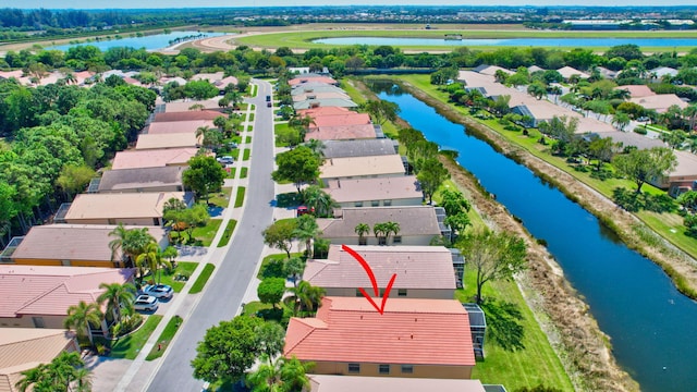 birds eye view of property with a residential view and a water view