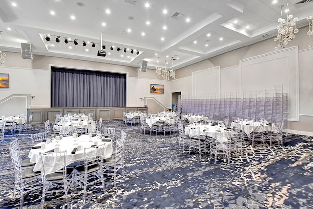 interior space with visible vents, coffered ceiling, and an inviting chandelier