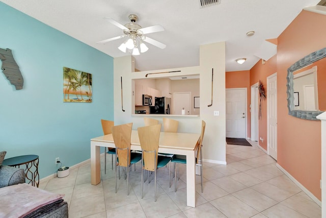 dining room featuring light tile patterned floors, visible vents, baseboards, and ceiling fan