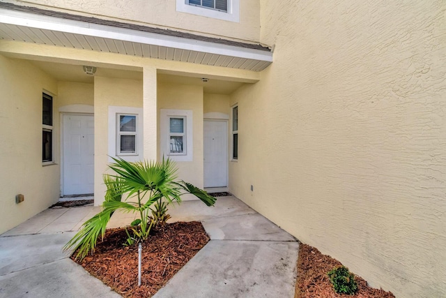 doorway to property with stucco siding