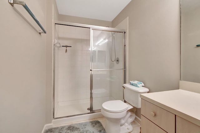 full bath with vanity, tile patterned floors, toilet, and a stall shower