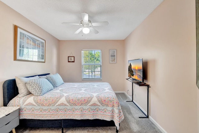 carpeted bedroom featuring baseboards and a ceiling fan