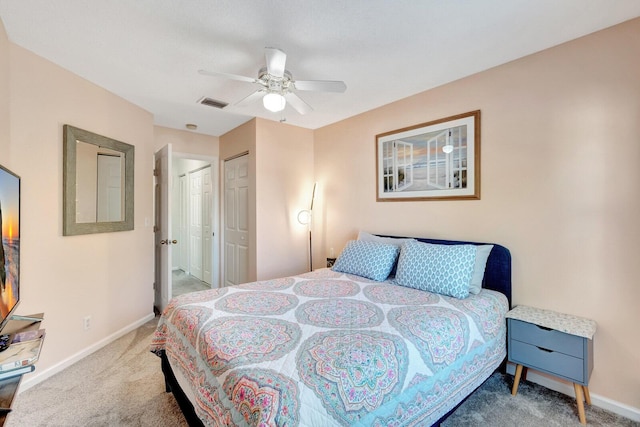 bedroom featuring a ceiling fan, carpet flooring, baseboards, and visible vents