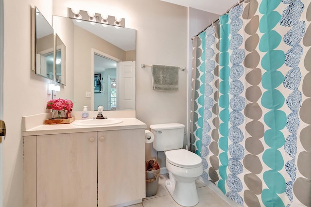 full bathroom with a shower with shower curtain, toilet, vanity, and tile patterned flooring