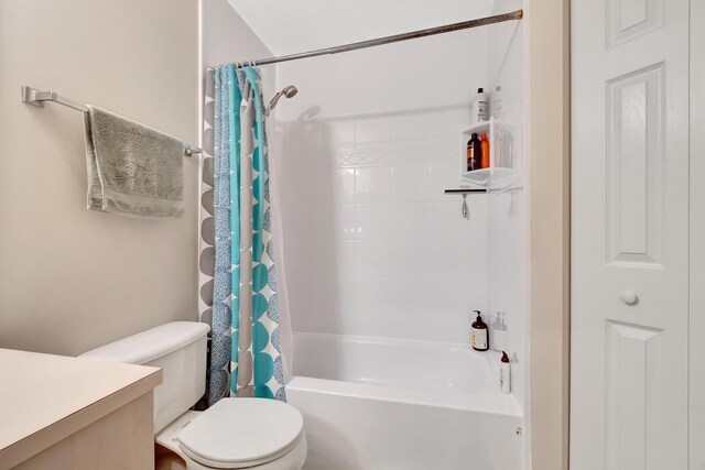 bathroom with vanity, toilet, and shower / bath combo with shower curtain