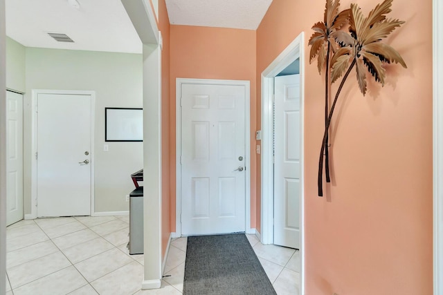 entrance foyer with light tile patterned flooring, baseboards, and visible vents