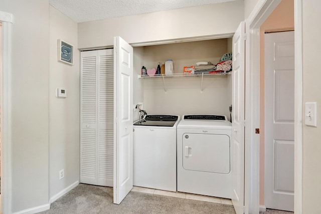 washroom with baseboards, laundry area, a textured ceiling, light carpet, and washing machine and dryer