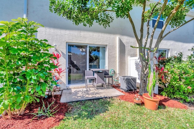 exterior space featuring central air condition unit, a patio area, and stucco siding