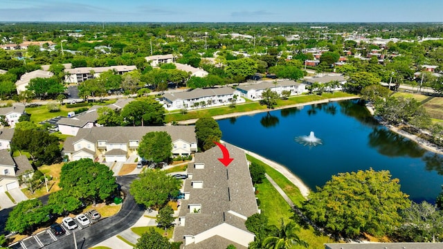 drone / aerial view with a water view and a residential view