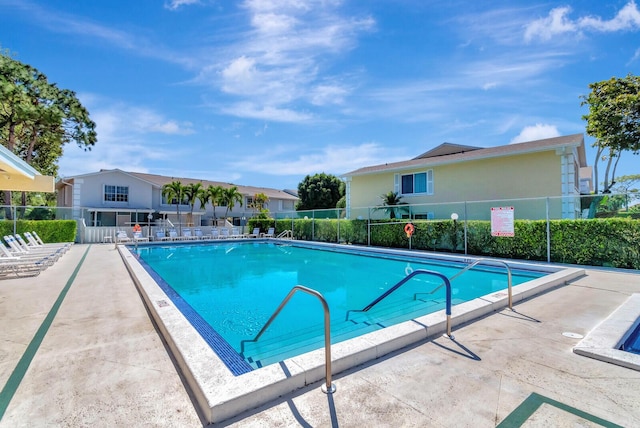 community pool featuring a patio area and fence