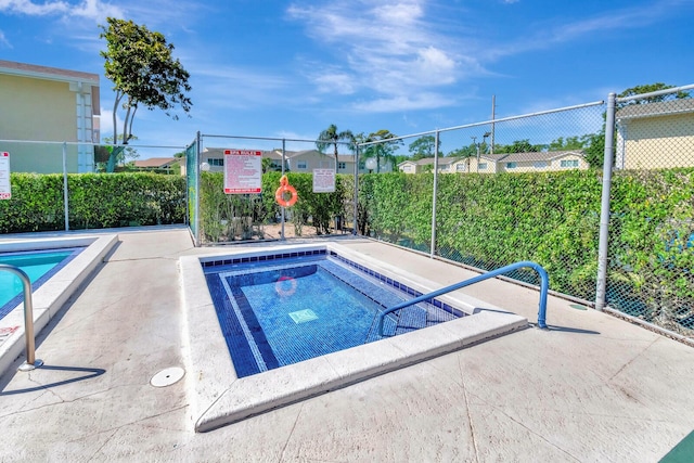 view of pool featuring fence