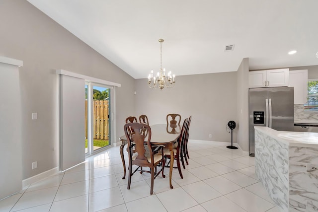 dining space featuring light tile patterned floors, visible vents, lofted ceiling, and a notable chandelier